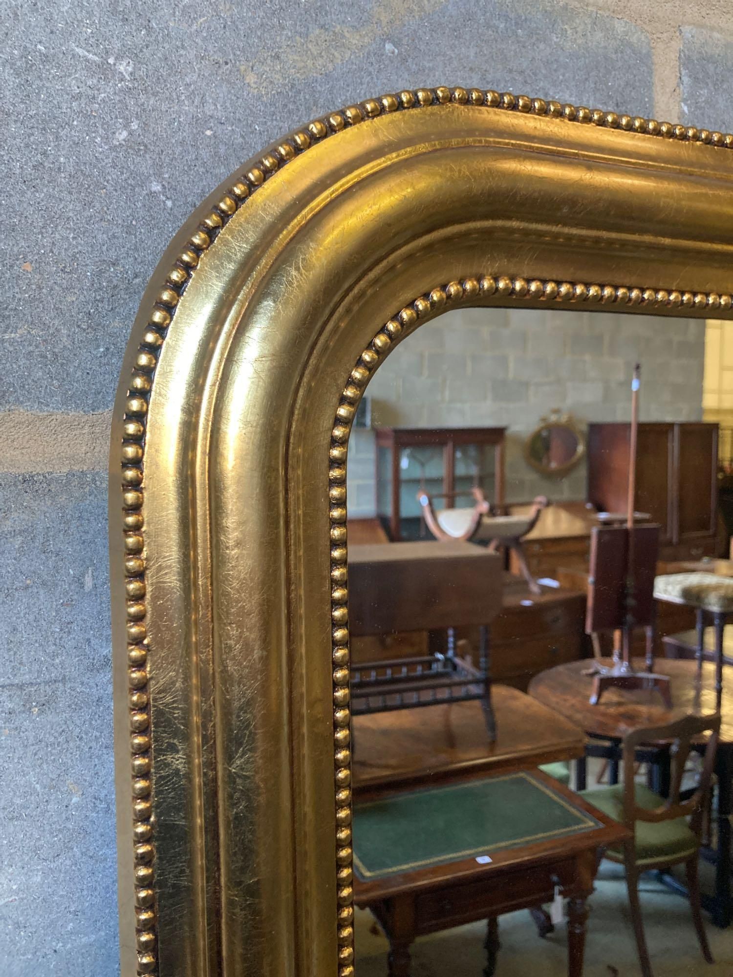 A modern gilt frame arched wall mirror, width 80cm height 100cm